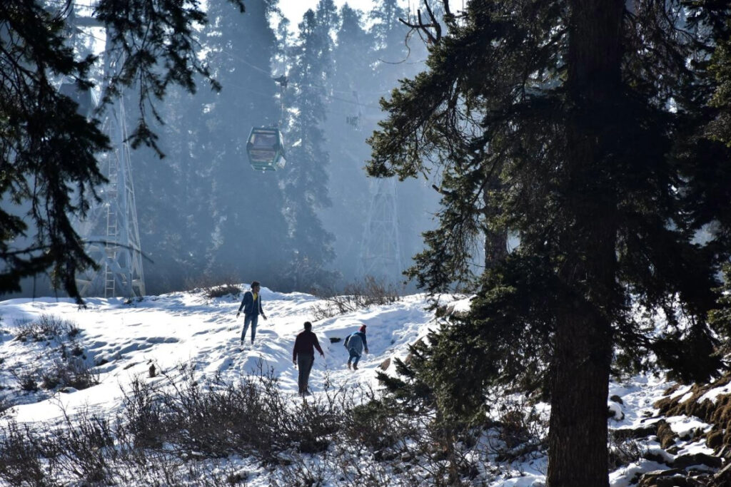 People under the cable car in Gulmarg during December
